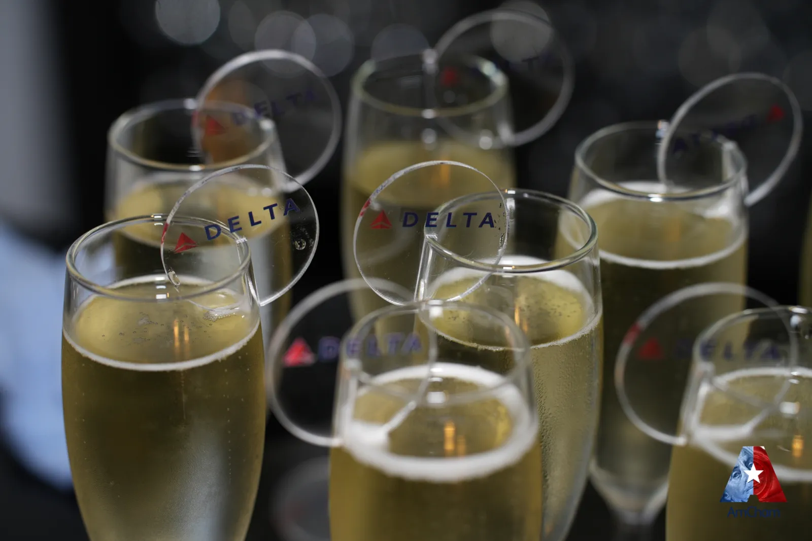 Sponsor-branded glassware at an event reception — branded detail and atmosphere footage that adds tangible value to sponsor deliverables.